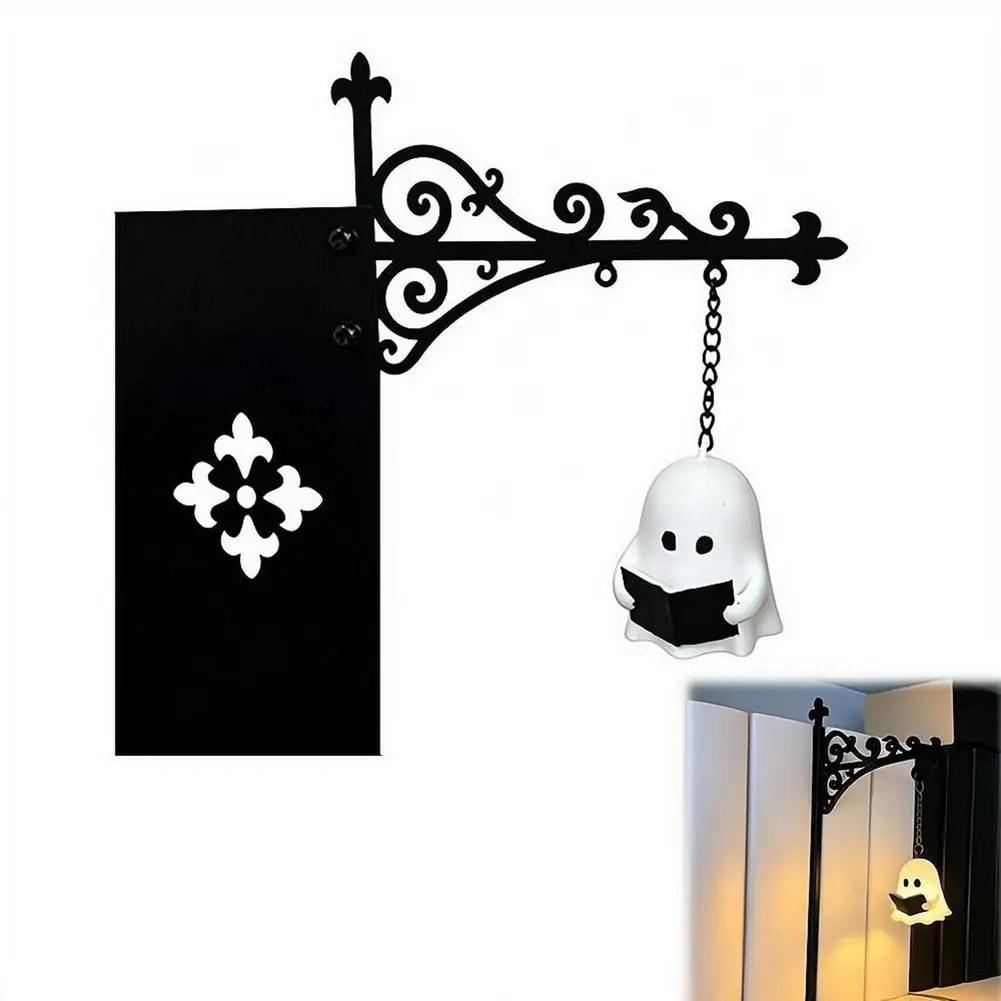 Ghost Reading Bookshelf Lamp — a small ghost reading, lit warm